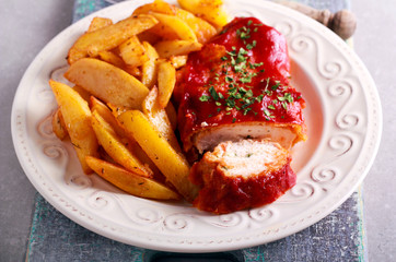 Chicken breast stuffed with mozzarella under tomato