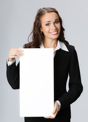 Businesswoman showing signboard, over grey