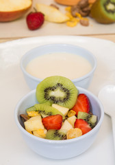 Fruit and cereal and milk in bowl