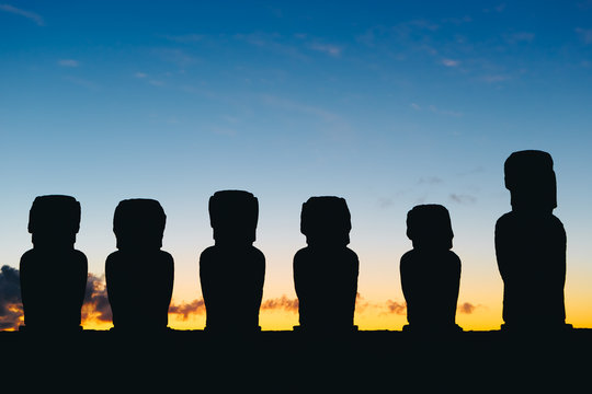 Fifteen standing moai on Ahu Tongariki against dramatic sunrise sky in Easter Island, Chile