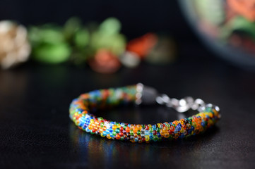Colorful bead bracelet on a dark background