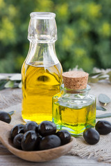Olive oil with leaves and olives