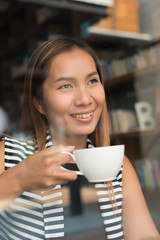 Asian woman relaxing with coffee at cafe. Women lifestyle concept.