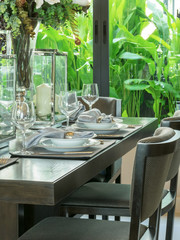 table set on wooden table and chairs in tropical dinning room