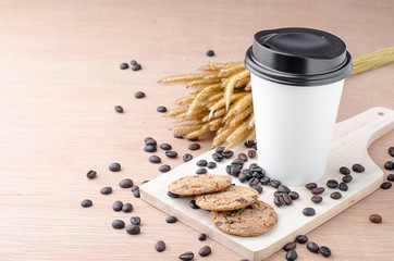Coffee cup and coffee beans on wooden background
