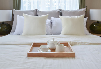 bedroom interior design with decorative tea set and dessert on bed