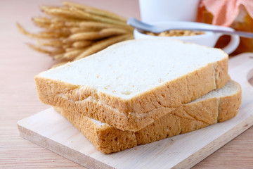 Fototapeta na wymiar slice of bread on wood background