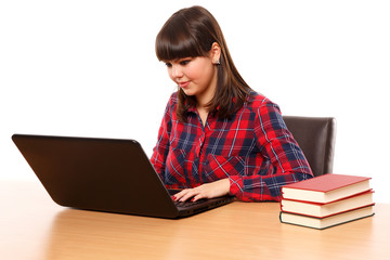 Teenage girl doing homework on laptop