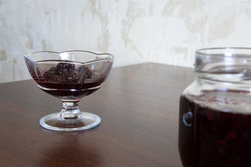 Blackberry jam in a glass jar and kremanke.