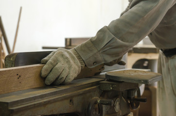 The carpenter was working furniture wood in studio , Soft-focus image
