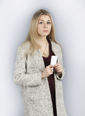 Fototapeta premium Girl holding a bank card on a light gray background 3