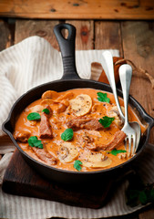 Beef Stroganoff with mushroom in iron pan