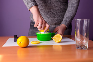 Girl is squeezing lemon