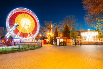 Fotobehang Rotating In Motion Effect Illuminated Attraction Ferris Wheel On © Grigory Bruev