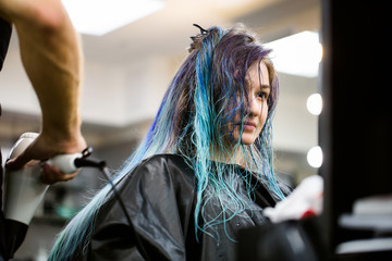 Making hairstyle using hair dryer.