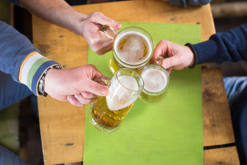 Group of friends having beer in a bar
