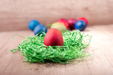 Happy Easter, red egg in a nest of grass