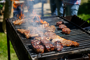 Hot meat is cooked on the grill