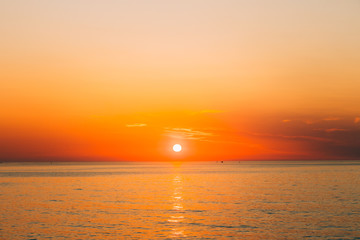 Sun Is Setting On Horizon At Sunset Sunrise Over Sea Or Ocean. T