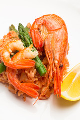 rice in tomato sauce with shrimp and asparagus closeup.