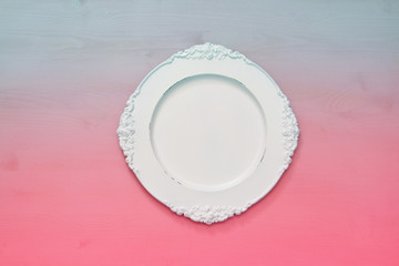 Top view of vintage white empty plate. Flat lay