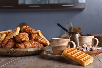 Breakfast with black coffee and fresh pastries