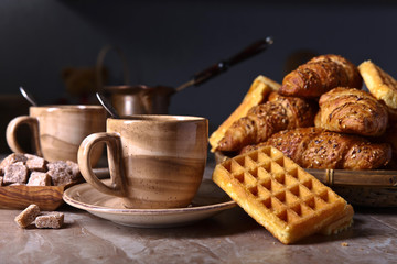 Breakfast with black coffee and fresh pastries