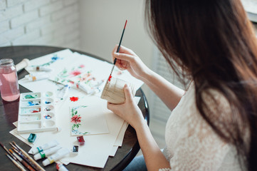 girl painter in white dress draws paints