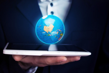 Businessman holding globe.