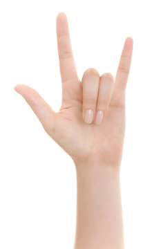 Hand shows the rock and roll sign or I love you sign isolated on a white background.