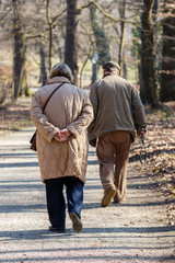 Older couple walking in park in early spring