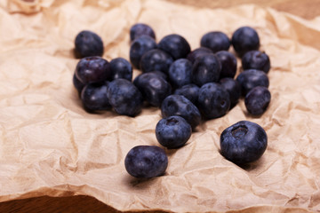 Fresh blueberries on a rustic brown paper background