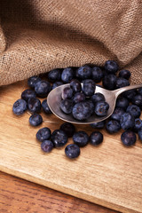 Blueberries and spoon on a rustic background