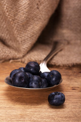 Blueberries and spoon on a rustic background