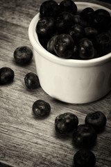 Pot of blueberries on a rustic background
