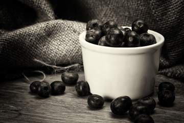 Pot of blueberries on a rustic background