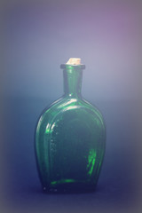 Old colourful bottles against a dark background