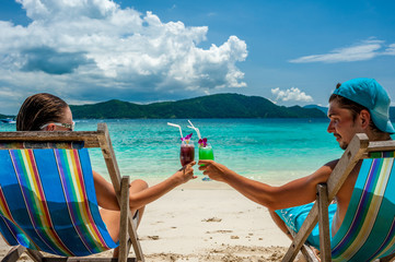 Couple in loungers on a beach at Thailand