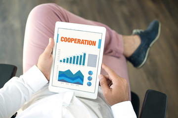 Business Charts and Graphs on screen with COOPERATION title