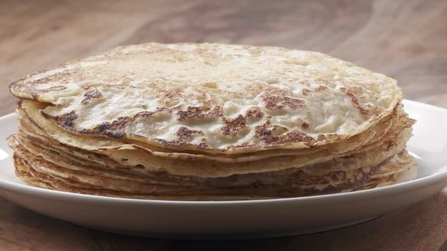 Slow motion of blin or crepe falling on stack, 180fps prores footage