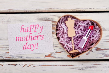 Heart-shaped box and lipstick. Create holiday for mother.