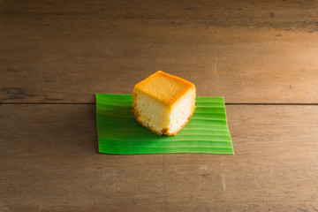 Sliced butter cake on wooden background
