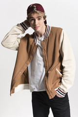 Young fashionable and Handsome man poses at white background in fancy clothes