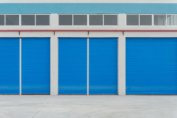 blue metal shutter doors on commercial shop front