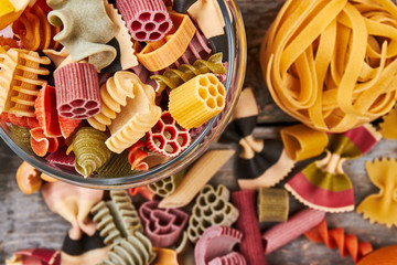 Glass jar with colored Italian pasta.
