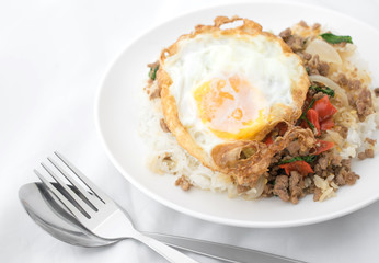 Fried basil leave with meat, Fried egg on rice spicy thai food.