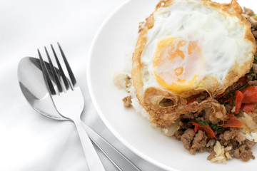 Fried basil leave with meat, Fried egg on rice spicy thai food.