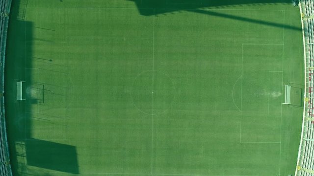Aerial footage of a football stadium, the shot is moving down to the center...