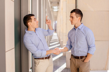 Obraz premium Two businessman shaking hads to each other with street city blur background