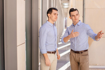 Two businessman talking about business with street city blur background